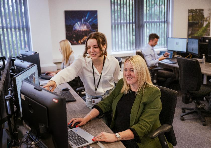 Two colleagues working together at a computer