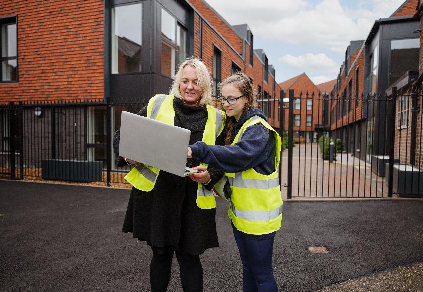 Two colleagues out on site looking at a laptop